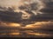 Dramatic sunset sky over Galway bay, Atlantic ocean, Ship silhouette , Reflection in the water, Burren mountains in the background