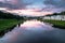 Dramatic sunset sky over the Tvertsa River and its picturesque shores after storm. Russian provincial town Torzhok, Tver region.