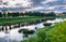 Dramatic sunset sky over the Tvertsa River and its picturesque shores after storm. Russian provincial town Torzhok, Tver region.