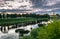 Dramatic sunset sky over the Tvertsa River and its picturesque shores after storm. Russian provincial town Torzhok, Tver region.