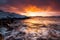 Dramatic sunset on snow-covered coast. Norway