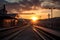 dramatic sunset, with train station platform in the foreground and the sun sinking below the horizon