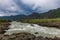 Dramatic thunderstorm clouds over the mountains in the upper reaches of the Katun River in the Altai