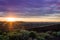 Dramatic ultra violet summer sunset over farm wooden onion crates