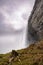 Dramatic unique view behind a powerful roaring waterfall