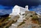 Dramatic view of Christian Orthodox church in the town of Chora in Serifos island, Greece under cloudy sky