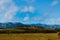 Dramatic view of Minas Gerais hills and farms in different tones of green and a cloudy sky in the afternoon