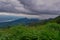 Dramatic view in the mountains during heavy rain in Thailand. There are very dark clouds and streams of rain