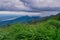 Dramatic view in the mountains during heavy rain in Thailand. There are very dark clouds and streams of rain