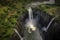 dramatic waterfall scenes shot from above, with the water cascading down into a pool below