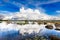 Dramatic white cloud over a bright blue lake