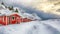 Dramatic winter scenery with traditional Norwegian red wooden houses on the shore of Rolvsfjord