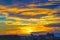 Dramatic yellowish sunset with cloudy sky over Cologne, Germany