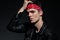 Dramatic young model wearing leather jacket and red bandana