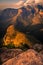 Dramatically lit portrait of the Three Rondavels and mountains w