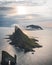 Drangarnir and Tindholmur on Faroe Islands Vagar, aerial drone view during sunset in North Atlantic Ocean. Faroe Islands