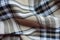 Draped beige, black and white flannel tartan fabric