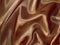 Draped chocolate-brown satin background