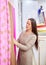 Drapery store owner looking at bright colored textile cloth