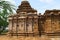 Dravidian vimana style sikhara and a view of the Devakoshthas on the south wall. Jain temple, Jinalaya, known as Jaina Narayana, P