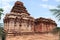 Dravidian vimana style sikhara and a view of the Devakoshthas on the south wall. Jain temple, Jinalaya, known as Jaina Narayana, P