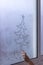 Draw a christmas tree on a foggy window