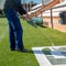 Draw letters on the grass in white over a template. The name of the football field on the grass