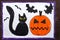 Drawing: Black cat, bad pumpkin and flying bats