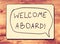 Drawing board with the phrase welcome aboard handwritten over wooden board