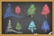 Drawing christmas tree on blackboard