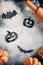 Drawing Halloween decorations on flour background, cakes in the shape of pumpkin and rolling pin. Halloween cooking concept