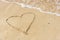 Drawing of a heart drawn on a sandy beach