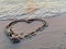 Drawing hearts on the sandy shore. Sign drawn on the sand, closeup. Concept: Declaration of Love