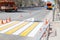 Drawing new coating on pedestrian crossing markings staining the zebra in white and yellow by restricting access to passing