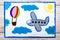 drawing: Small blue airplane and hot air balloon