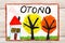 Drawing: Spanish word AUTUMN, house and trees with yellow and orange leaves