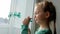 Drawing St. Patrick`s Day Child painting green three-leaved shamrocks indoor, festive home decoration, quarantine family leisure.
