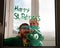 Drawing St. Patrick`s Day Father with daughter painting green three-leaved shamrocks indoor, quarantine family leisure