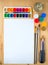 Drawing supplies watercolor brushes, aquarelle, gouache, paper on wooden background