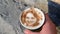 Drawing of a woman`s face on a foam coffee latte