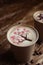 Drawings on coffee. Male and female cappuccino decoration. Hot drink in a paper cup. Picture of a chocolate mountain and Japanese