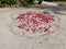 Drawn heart-shaped graffiti with lots of rose petals on the sandy beach