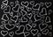Drawn hearts white white  on a black chalkboard