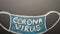 A drawn mask on a blackboard with the inscription Coronavirus. News headline, articles. Epidemic and pandemic, problems in