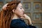 Dreadlocks closeup, fashionable girl posing at old wooden door background