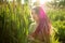 Dreadlocks woman wearing green shirt in a city park during a sunset, be free, boho, hippy lifestyle concepts