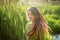 Dreadlocks woman wearing green shirt in a city park during a sunset, be free, boho, hippy lifestyle concepts