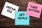 Dream big, set goals, take action concept - motivational advice or reminder on colorful sticky notes  on wooden table.