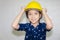 Dream careers concept, Portrait of Happy engineer kid in hard hat looking at camera on blurred background