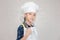 Dream careers concept, Portrait of Happy Kid chef looking at camera with blurred background